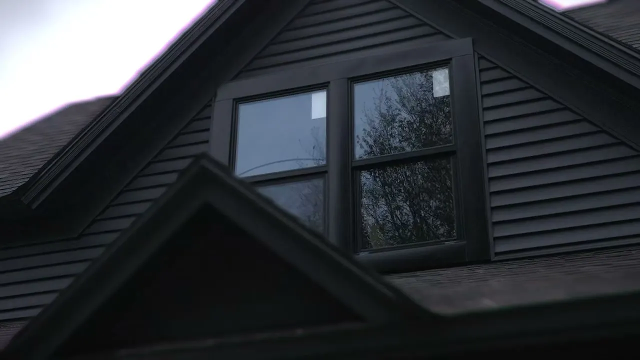 After: a new window in the dormer, framed in black trim and dark siding