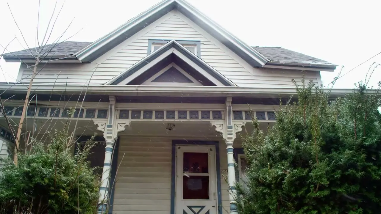 Before: the old porch with worn white posts and a faded door
