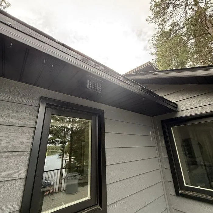 Black-framed windows set in new dark grey lap siding