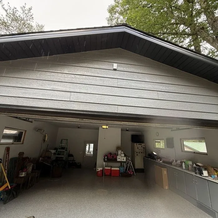 Detached garage re-sided in dark lap siding with black trim