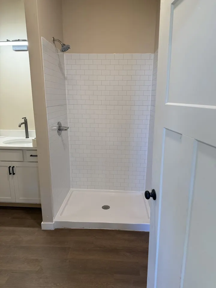 Finished walk-in shower in white subway tile