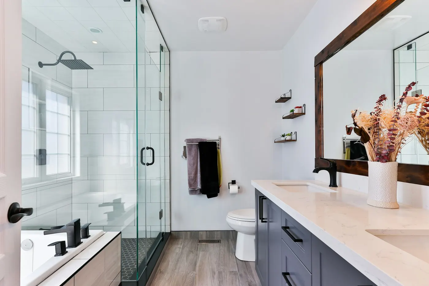 Renovated bathroom with a glass shower and black fixtures (representative photo)